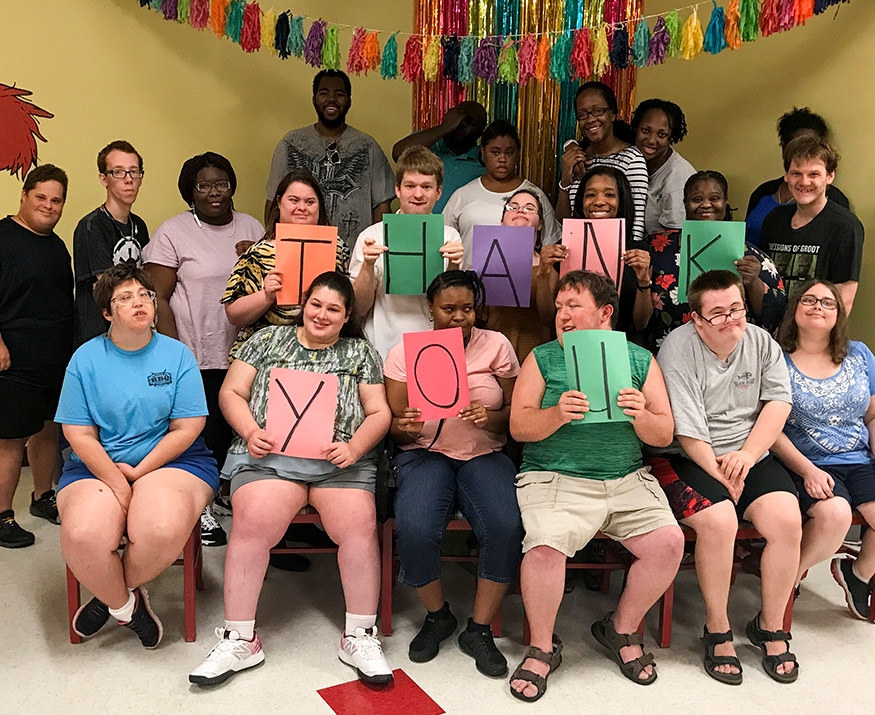 Group of kids holding letters