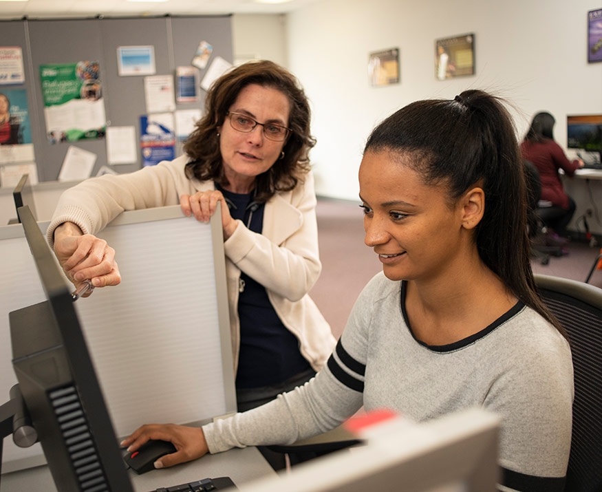 Teacher and student at computer